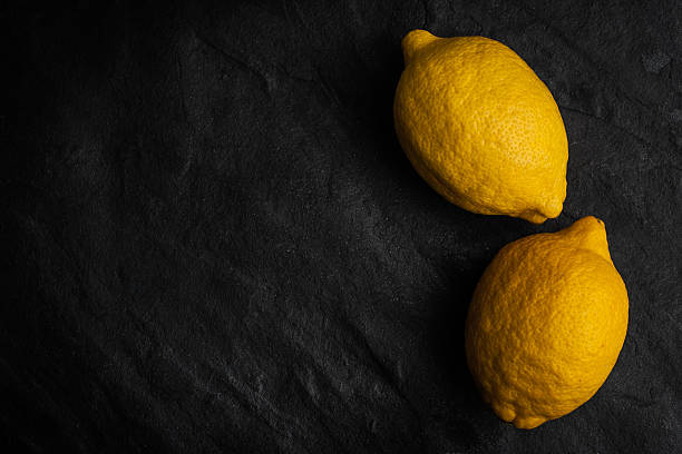 istock Yellow lemons  in the right side of  the black stone table 486668196