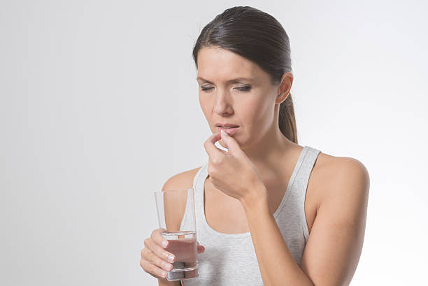 istock Attractive woman taking medication 486672963