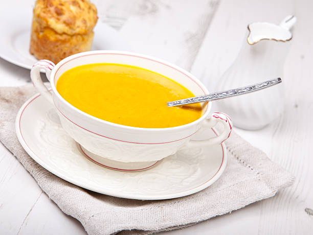 istock Lightly spiced carrot soup in bowl, on the white table 486674241