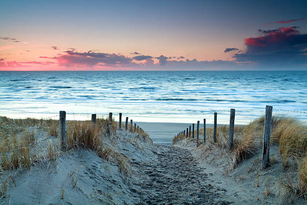 istock sunset over North sea sand beach 486676920