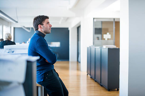 istock Thoughtful businessman leaning on desk at workplace 486677316