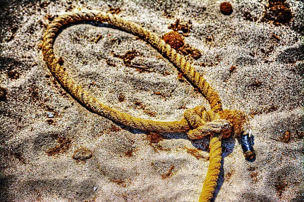 close up of a noose on the sand in hdr tone mapping effect
