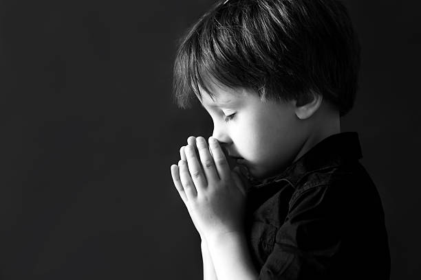 istock Little boy praying, child praying, isolated background 486682858