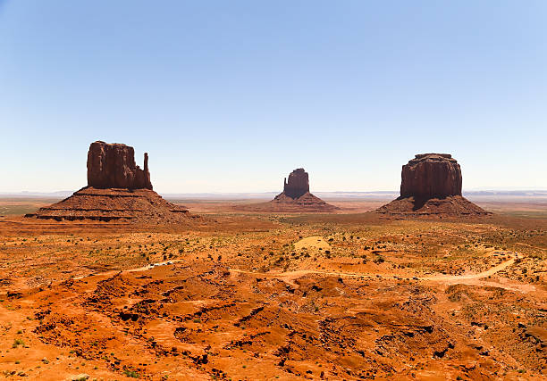 Western Scenery East and West Mitten Buttes and Merrick Butte in Monument Valley at daytime. david merrick photos stock pictures, royalty-free photos & images