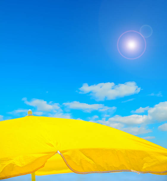 istock yellow parasol on the beach under a clear sky 486684038