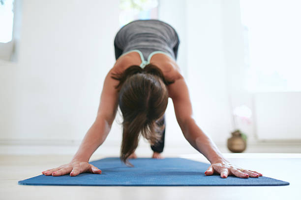 istock Woman doing Adho Mukha Svanasana yoga pose 486684722