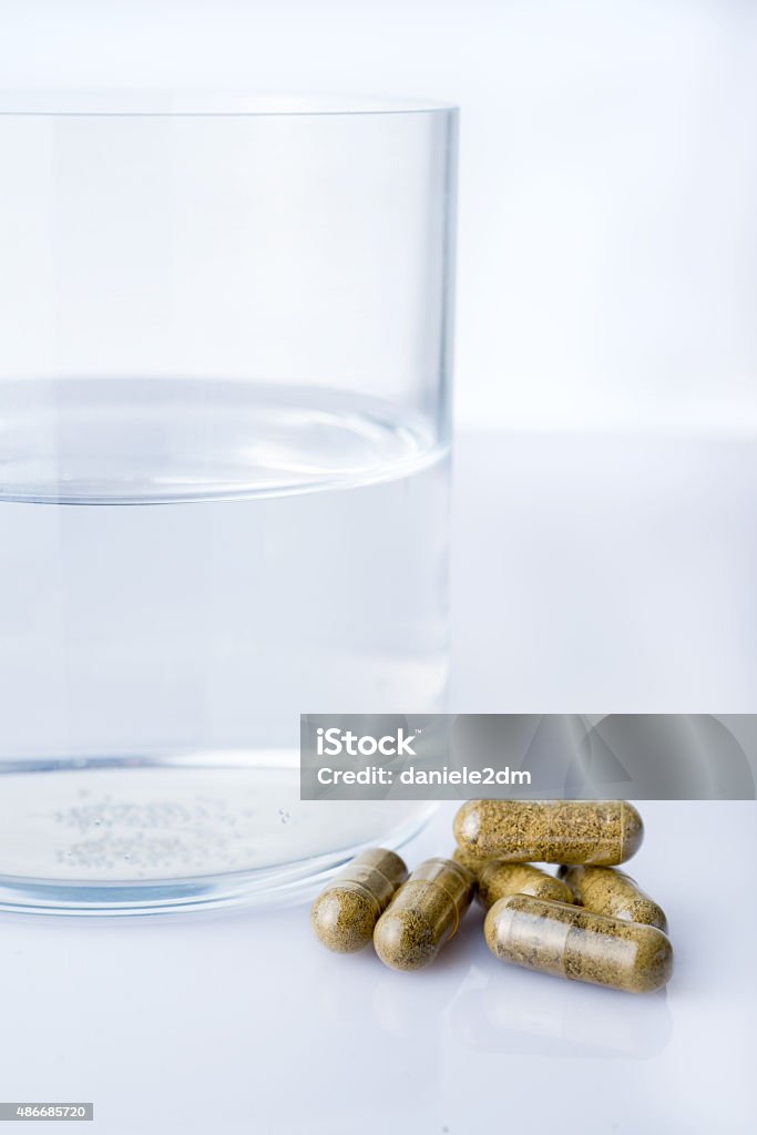 Glass of water with homepathy pills 2015 Stock Photo