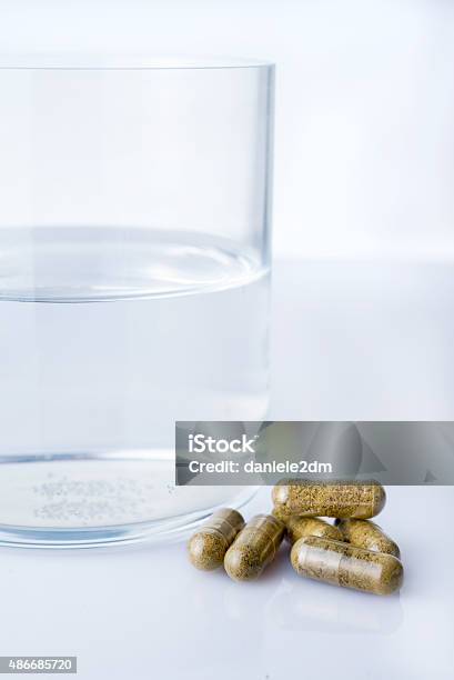 Glass Of Water With Homepathy Pills Stock Photo - Download Image Now - 2015, Capsule - Medicine, Choice