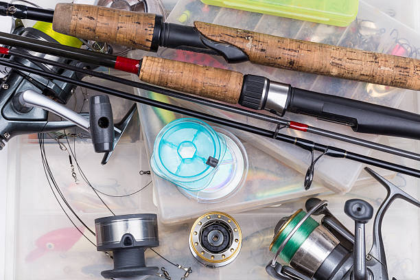 istock fishing tackles - rod, reel, line and lures in box 486689112