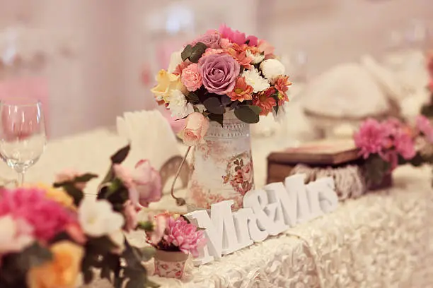 Beautifully decorated wedding table with flowers and MR&MRS letters