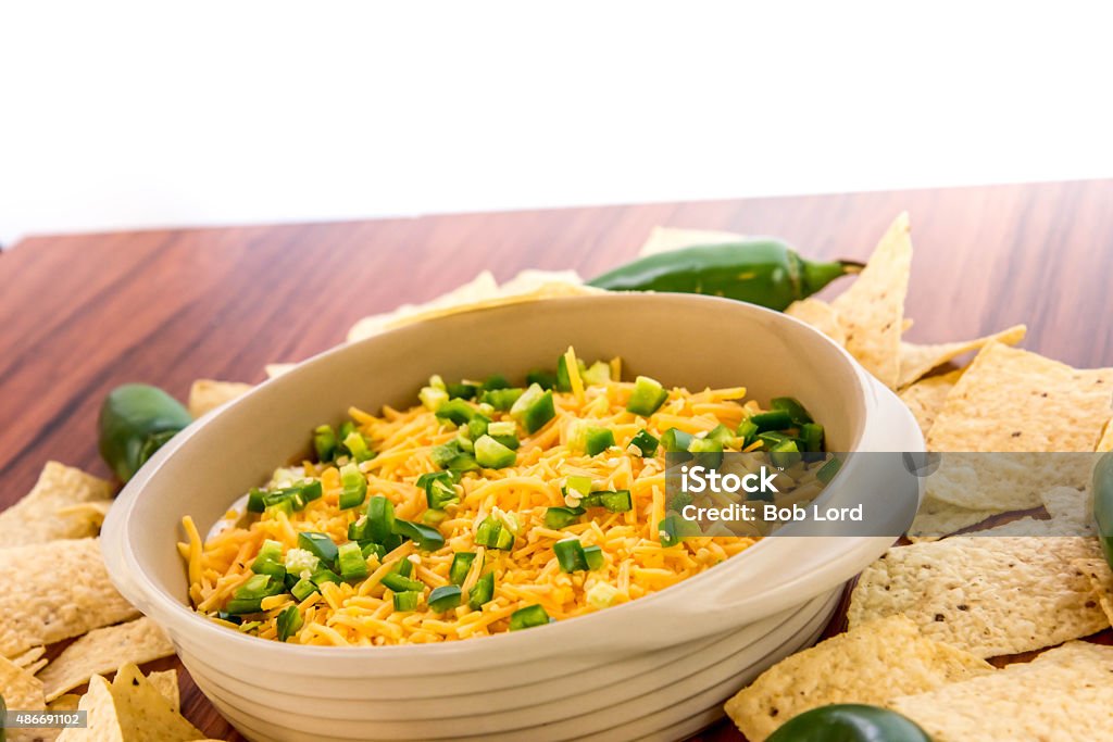 bean dip with jalapenos, sour cream and cheddar cheese preparation of layered bean dip with jalapenos, sour cream and cheddar cheese 2015 Stock Photo