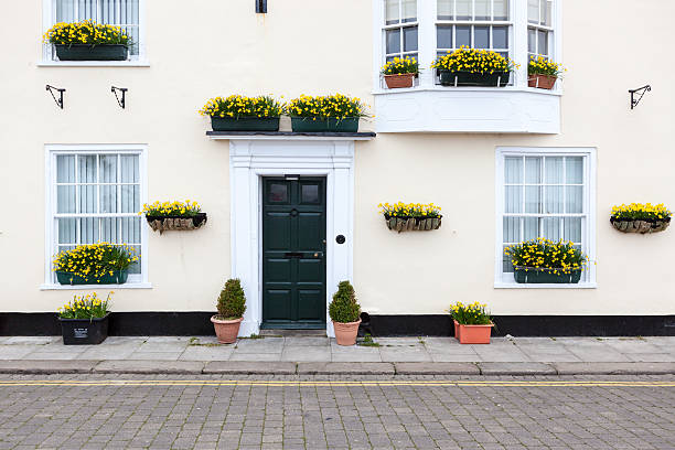 istock Pastel painted house with flowering baskets. 486692497