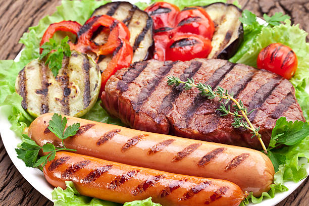 istock Grilled steak,sausages and vegetables over lettuce leaves. 486693797