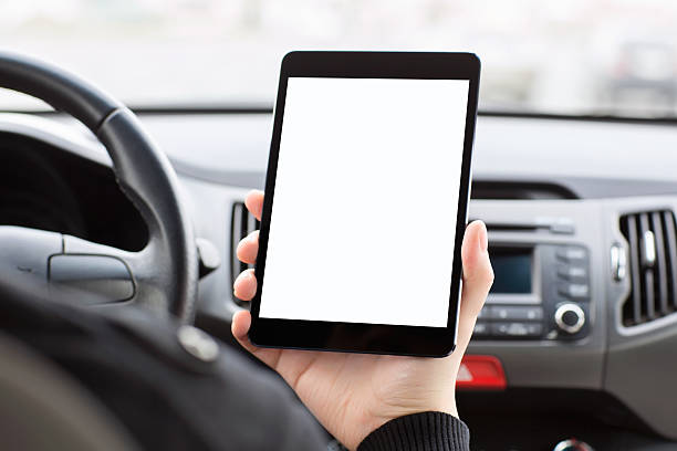 istock man sitting in the car and holding a tablet 486693991