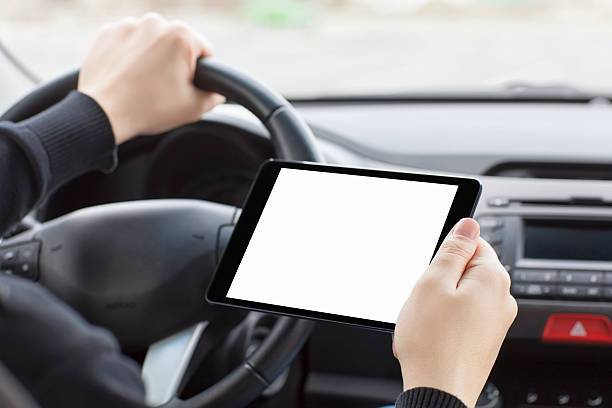 istock man in car and holding a tablet with isolated screen 486694943