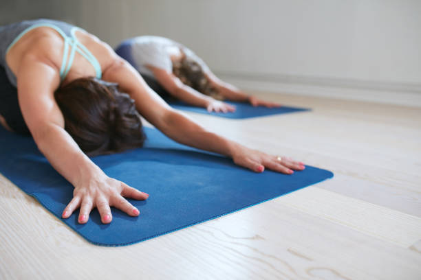 istock Two women relaxing in child pose doing yoga 486695394