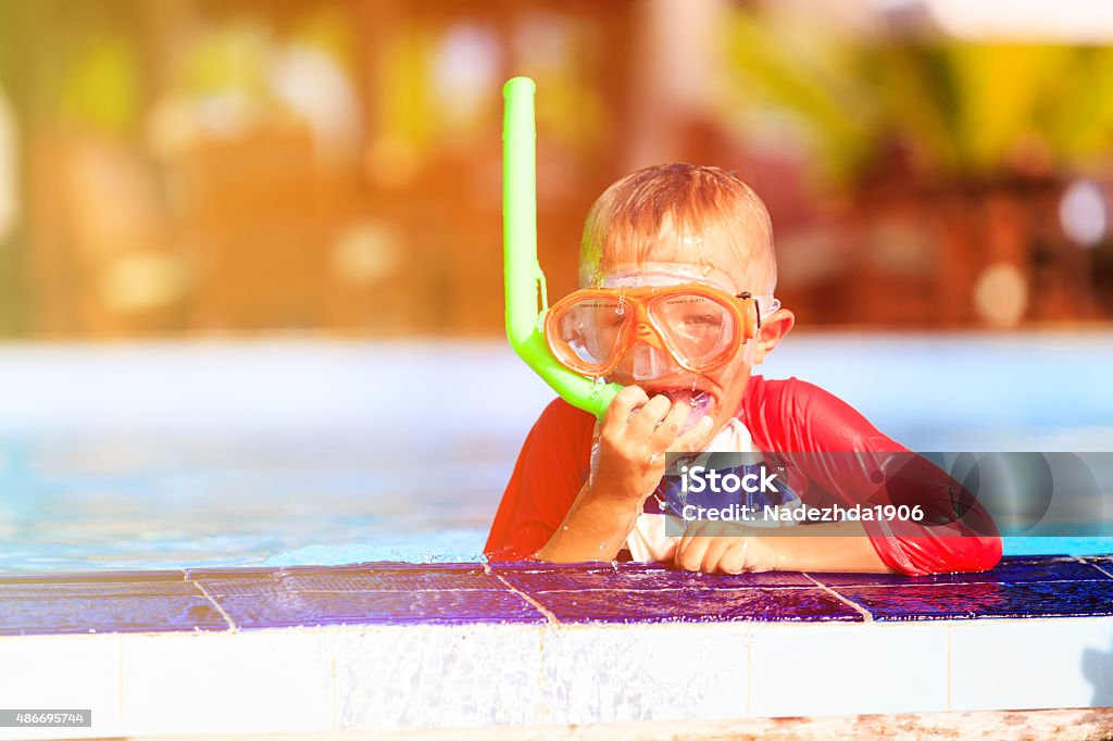 little boy swimming with mask in pool little boy swimming with mask in outdoor pool 2015 Stock Photo