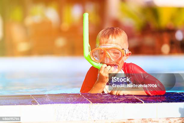 Little Boy Swimming With Mask In Pool Stock Photo - Download Image Now - 2015, Activity, Boys