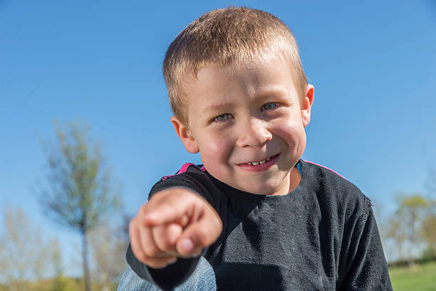 istock Child smiles at the park is pointing 486696212