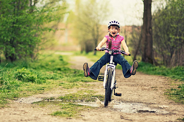 little girl riding a bike - helmet bicycle little girls child fotografías e imágenes de stock