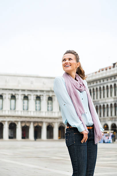 istock Smiling woman looking over shoulder on St. Mark's Square, Venice 486696702