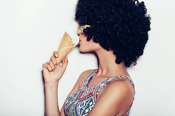 Sexy happy young woman eating ice cream stock photo