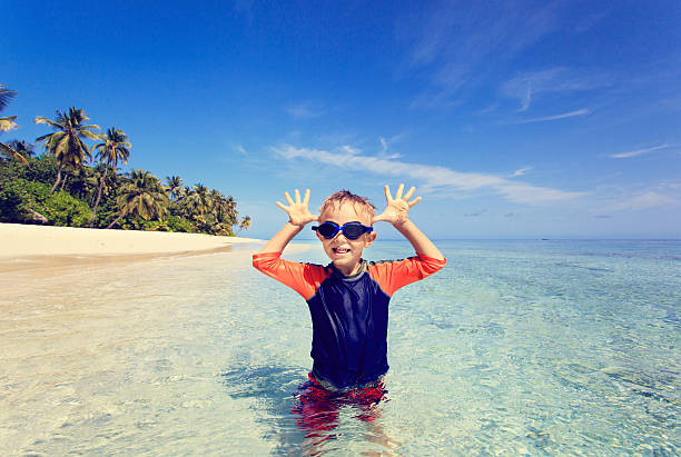 istock little boy having fun on tropical beach 486696750