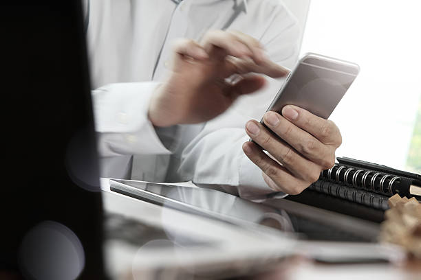 istock Businessman hand using laptop and mobile phone 486701688