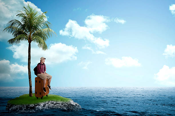 istock Asian tourist sit on the suitcase on the small island 486704732