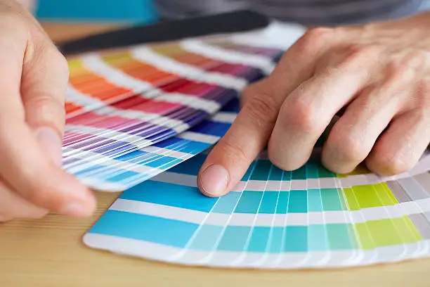 Graphic designer choosing a color from the palette