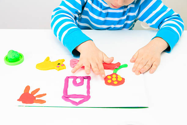 istock little boy playing with clay dough, education and daycare 486707636