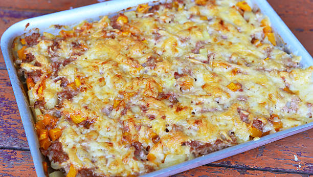 meat casserole with cheese on baking sheet stock photo
