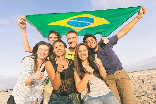 Photo of Group of Friends with Brazilian Flag at Beach