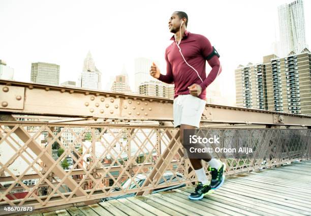 Man Running On The Brooklyn Bridge Stock Photo - Download Image Now - New York City, Running, Healthy Lifestyle