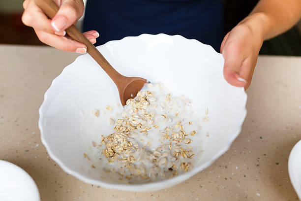 istock Young woman making a dough from oatmeal 486709294