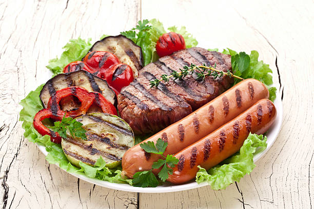 istock Grilled steak,sausages and vegetables on a plate. 486710529