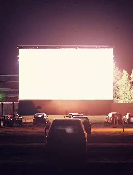 Drive in movie goers enjoy a screening under clear Autumn skies. Long exposure.