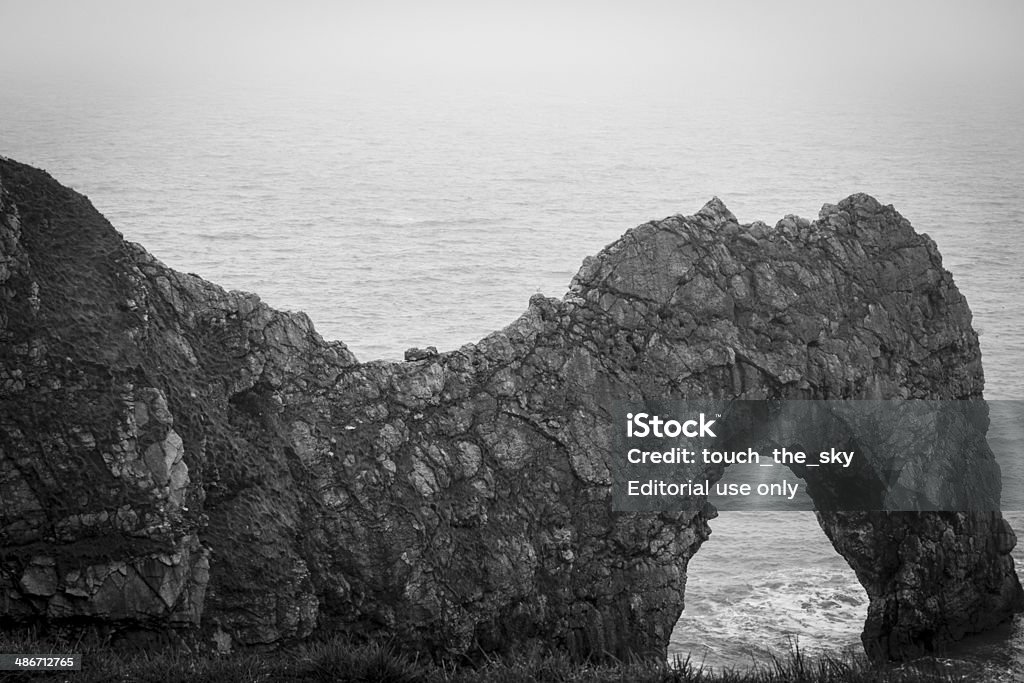 Durdle Door 2 Dramatic, spectacular view of the legendary natural limestone arch on the Jurassic Coast near Lulworth. Black and White photo. Awe Stock Photo