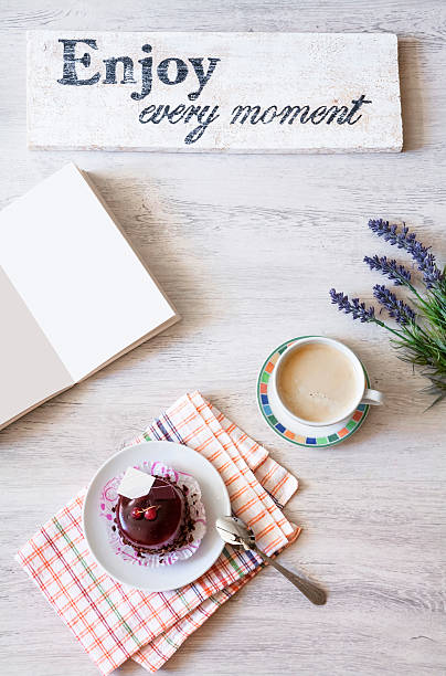 Cup of coffee with dessert and notebook on the table