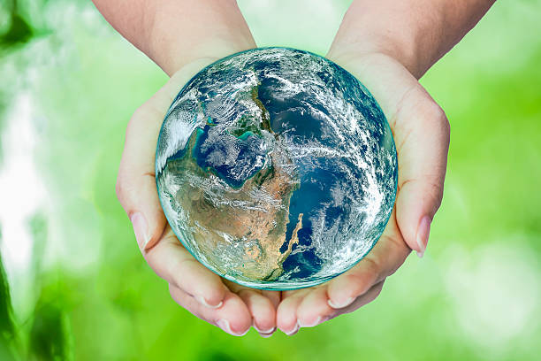 istock Woman holding globe on her hands 486714152