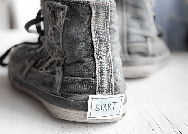 Tag with the word start on sneakers. stock photo