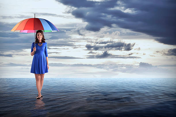 istock Man Holding Umbrella In The Sea 486716992
