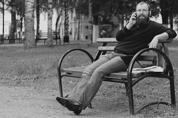 istock man reading books in the park 486719750