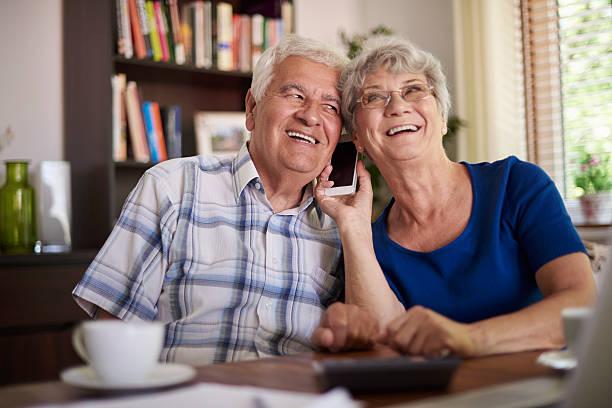 istock Grandparents talking on the phone at the table 486720826