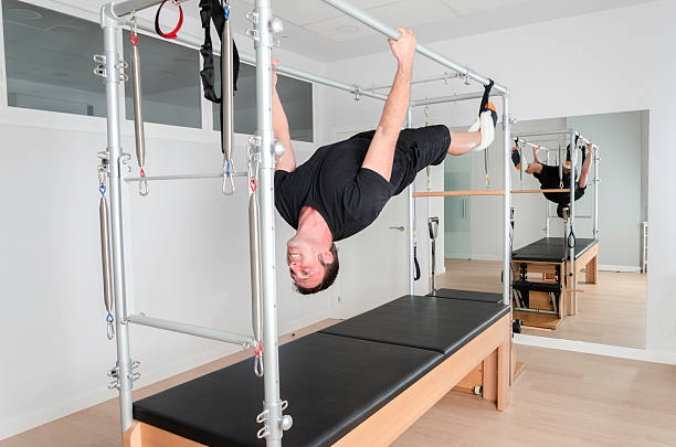 istock Man doing pilates in cadillac. 486723494