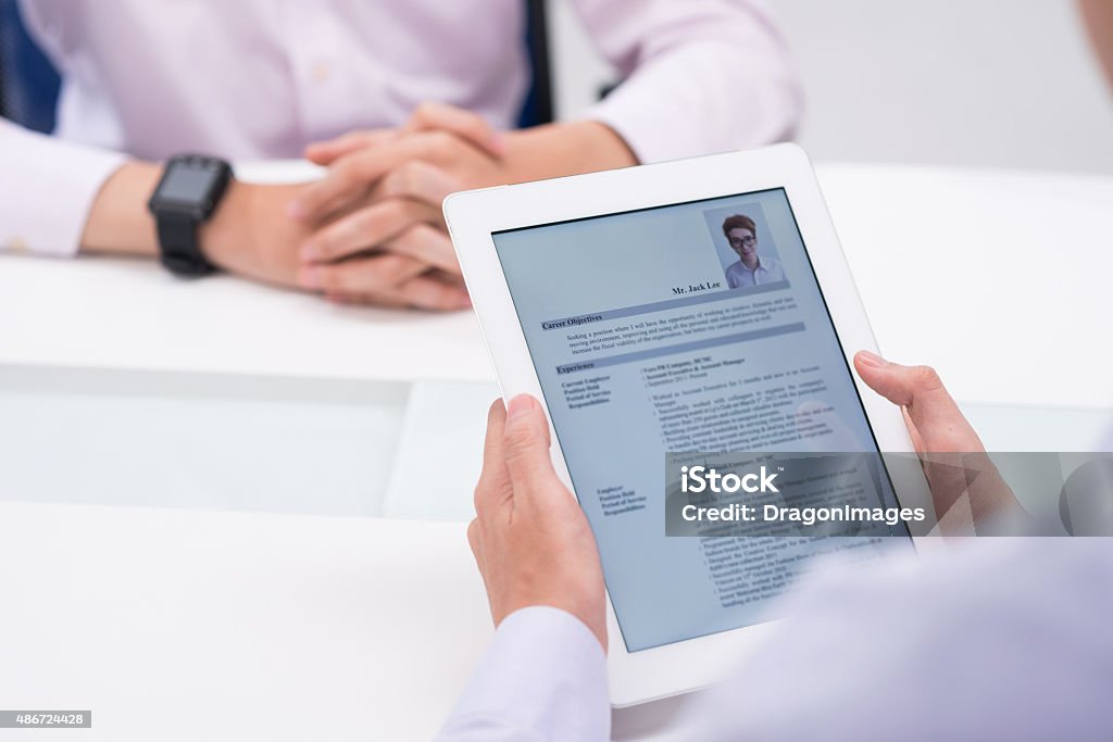 Reading cv Close-up image of employer reading cv of job candidate Résumé Stock Photo