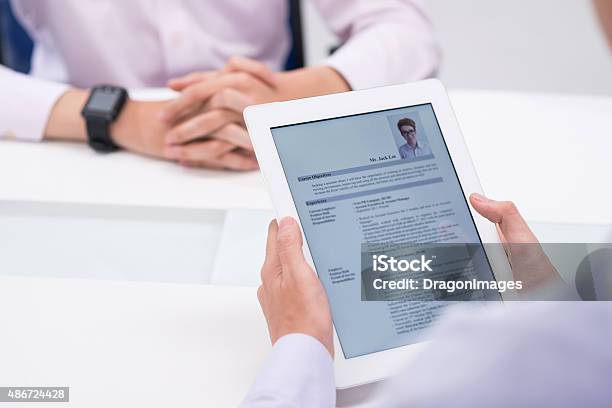 Reading Cv Stock Photo - Download Image Now - Résumé, Interview - Event, Digital Tablet