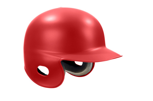 A red batter's helmet against a white background. This helmet can be used for various team sports like baseball, softall and T-Ball