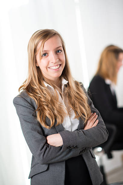 istock Cheerful young business woman standing up 486725017
