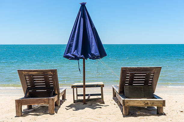 istock Colorful wooden beach chairs with sun umbrella 1 486725228
